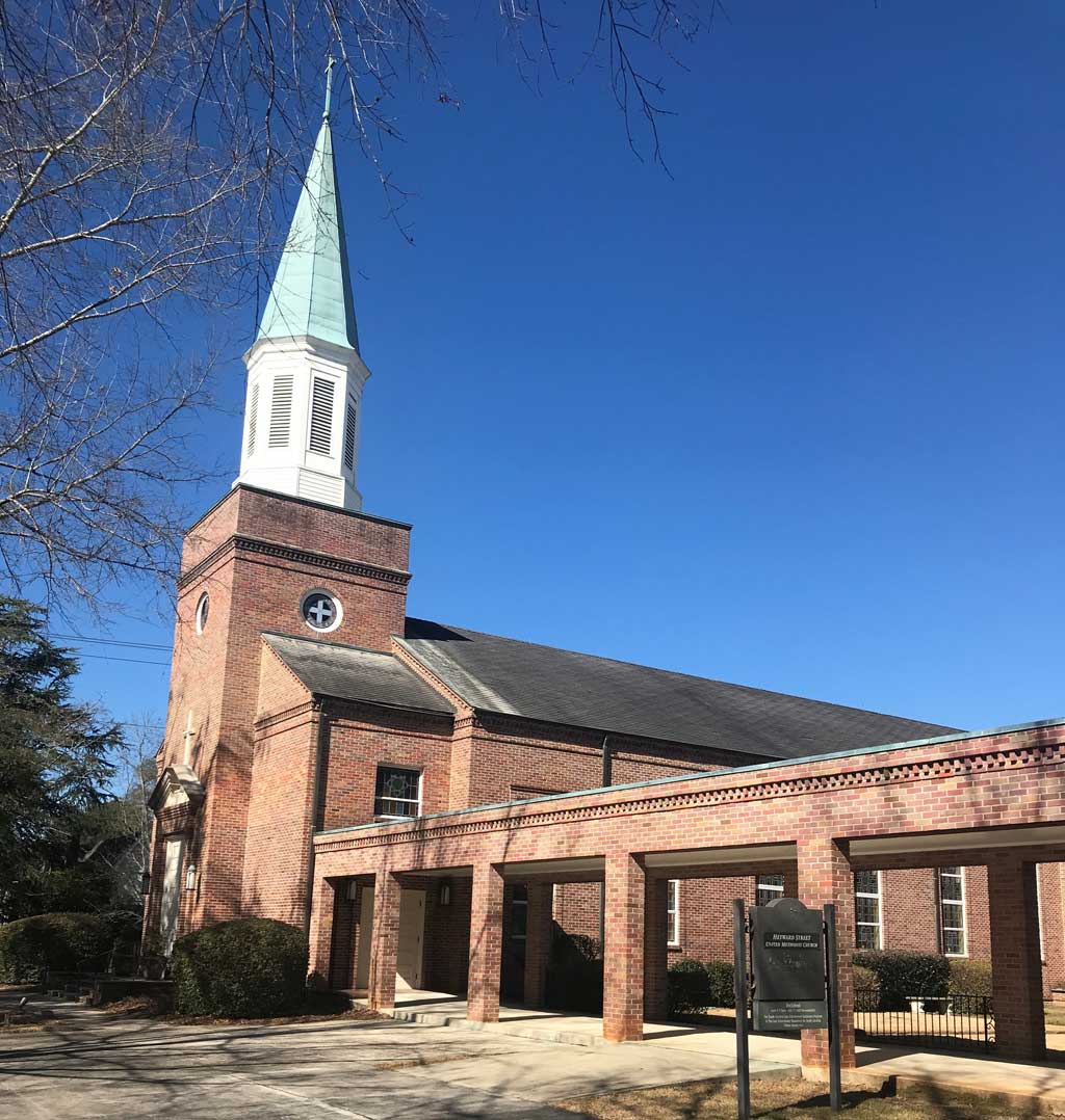 Wide angle view of the church, Heyward St United Methodist Church, during daylight hours.
