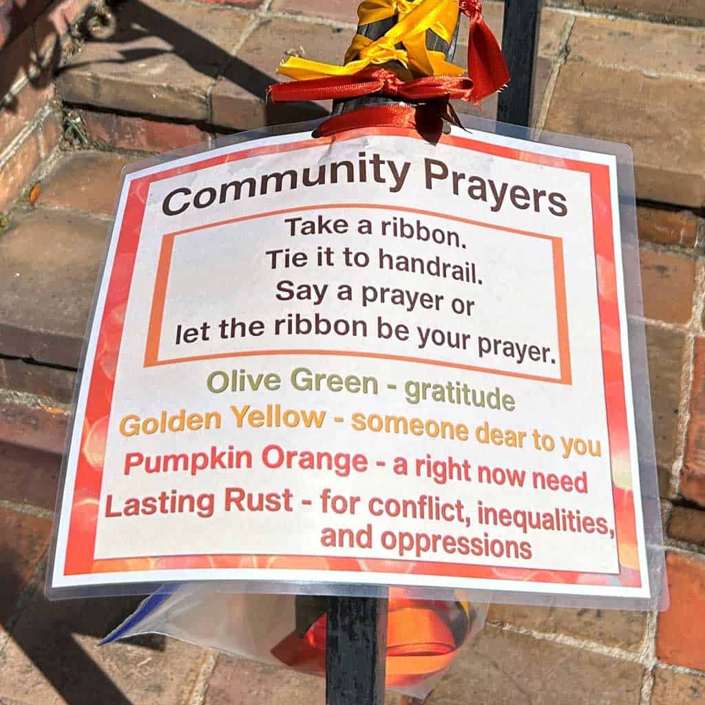 Community prayer outreach with ribbons to take based on need.